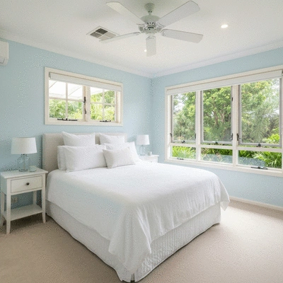 Modern Queensland bedroom with white linen bedding and natural light