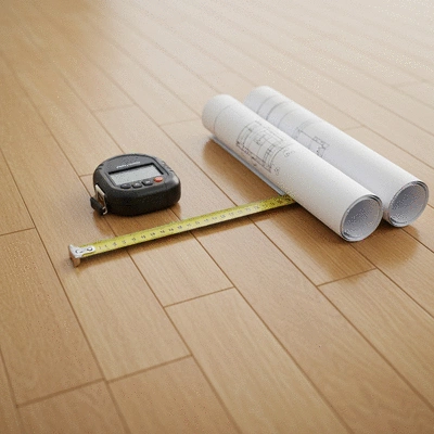 Modern construction tools and blueprints lying on a wooden floor during a home inspection
